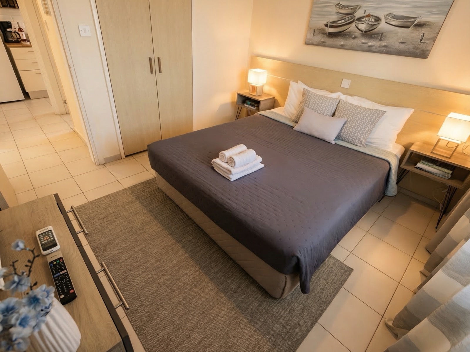 Bedroom with queen bed and fresh towels