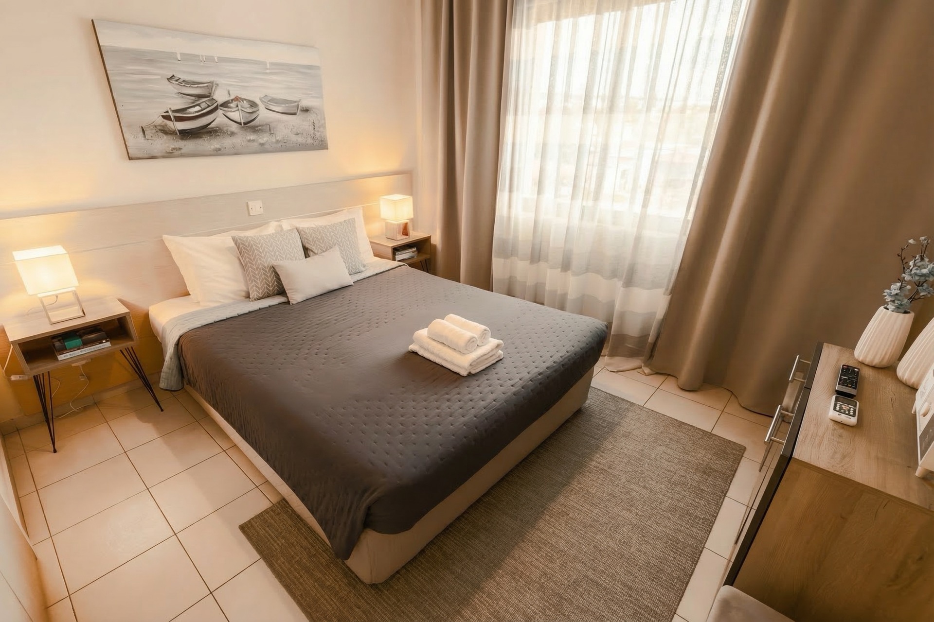 Bedroom with queen bed and harbour painting